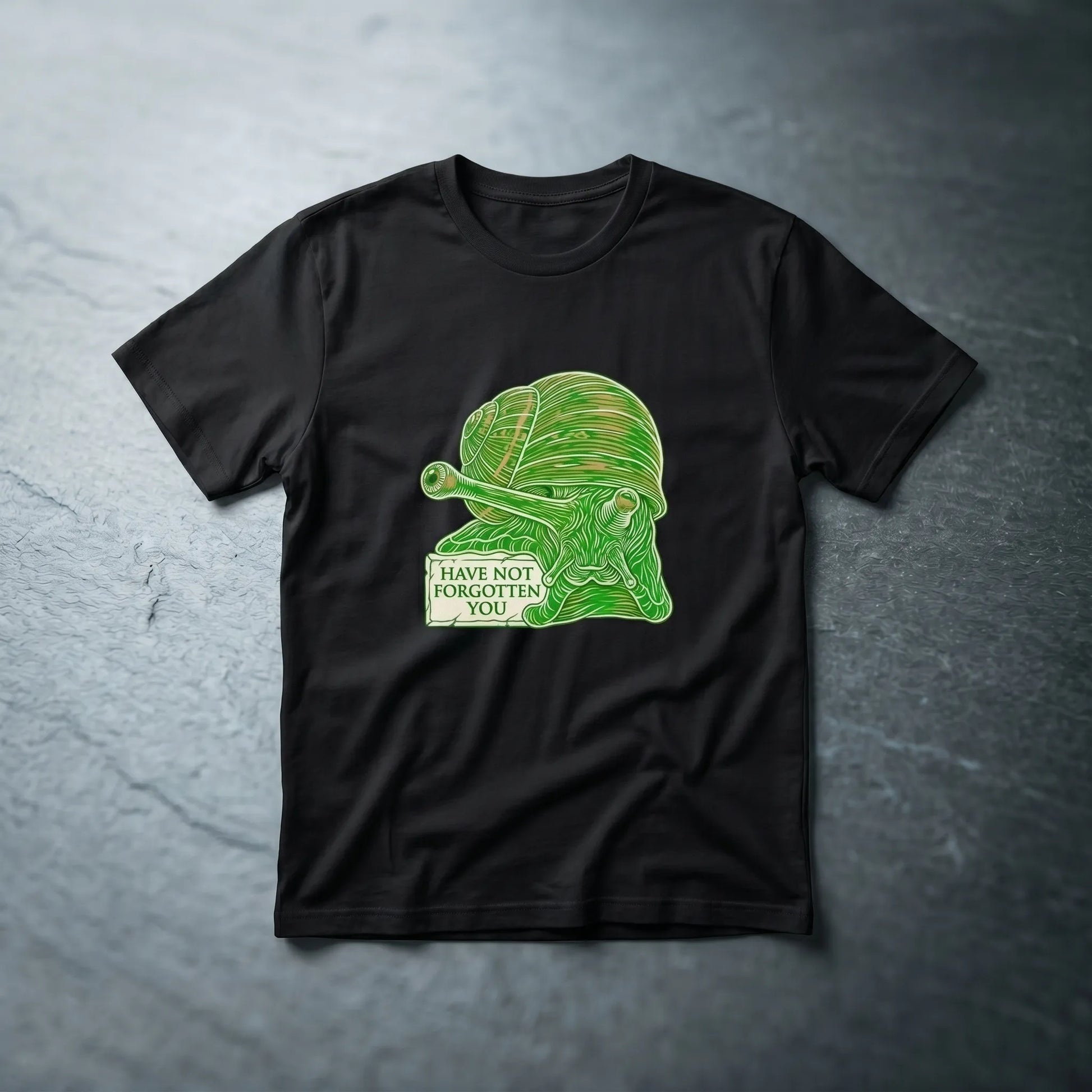 Main front view of the Immortal Snail Meme Tee featuring an extreme close-up of the snail assassin and the caption 'have not forgotten you', an existential humor gift for reddit lifers.