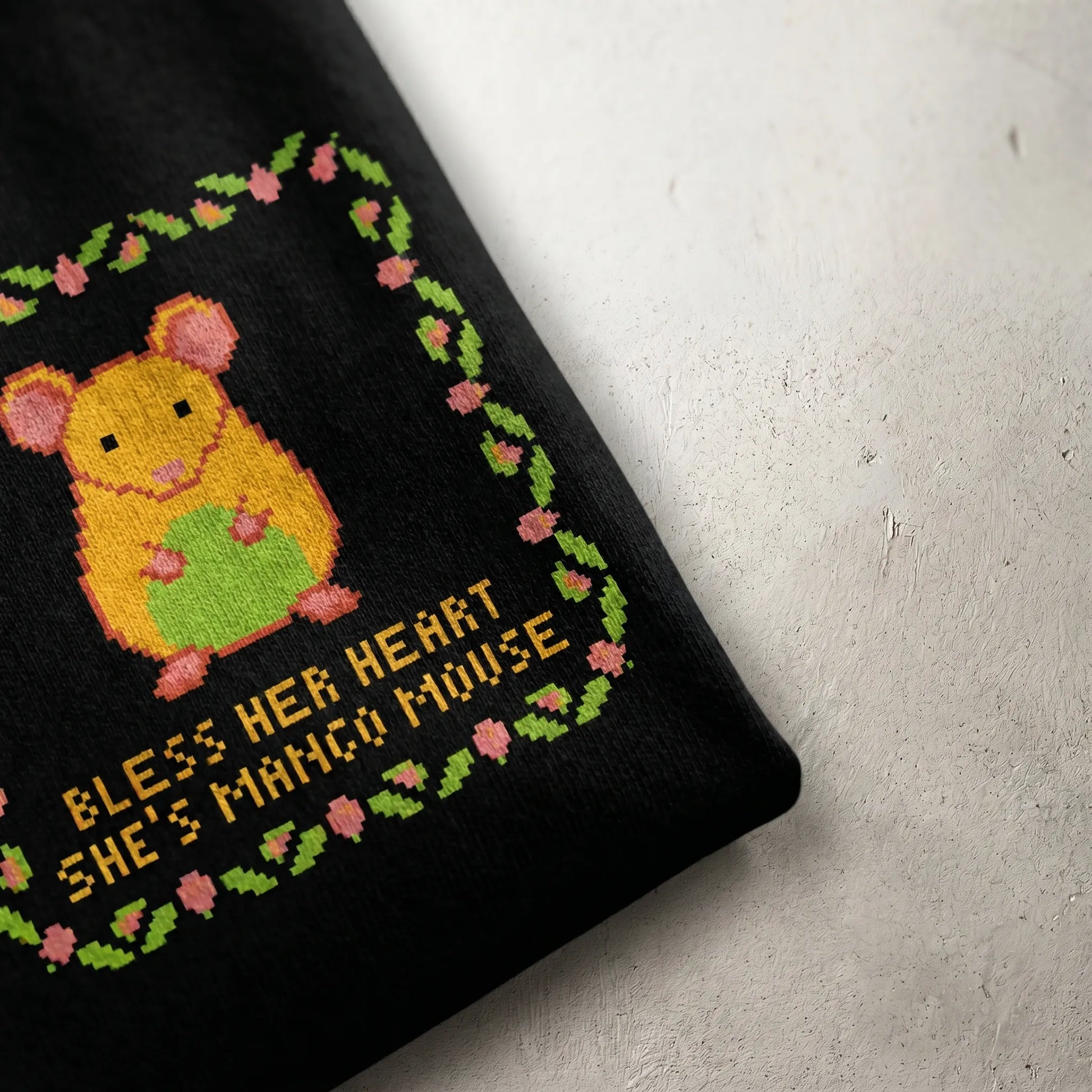 Close-up detail of the DTG soft-hand print on a Mangomouse Cross-Stitch Tee, highlighting the Southern grandmother style embroidery effect on heavyweight 100% cotton fabric.